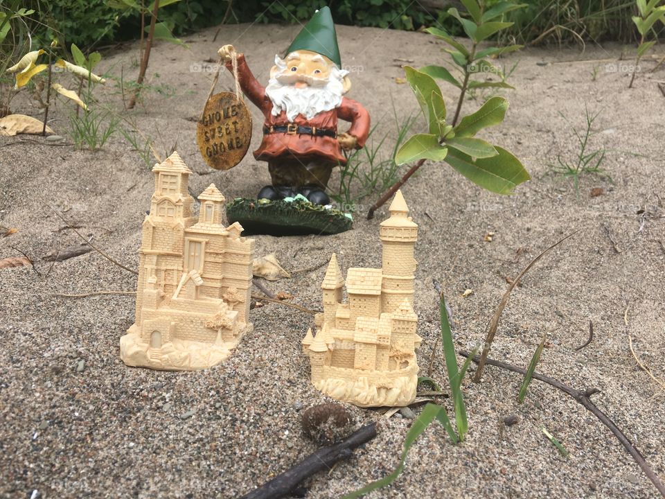 Traveling Gnome builds two sand castles while on a beach trip. 