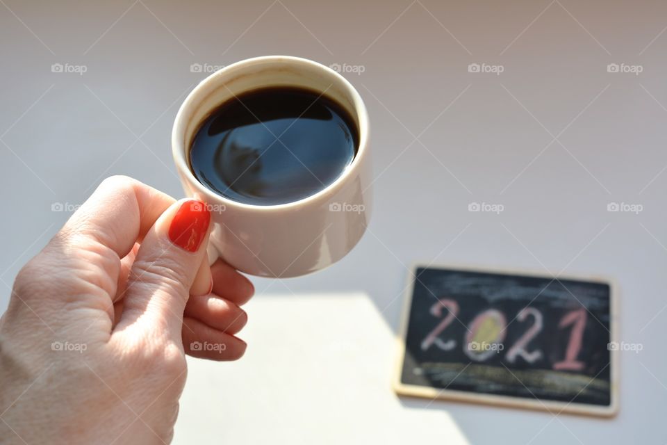 coffee cup in the female hand on a white background, 2021, mug