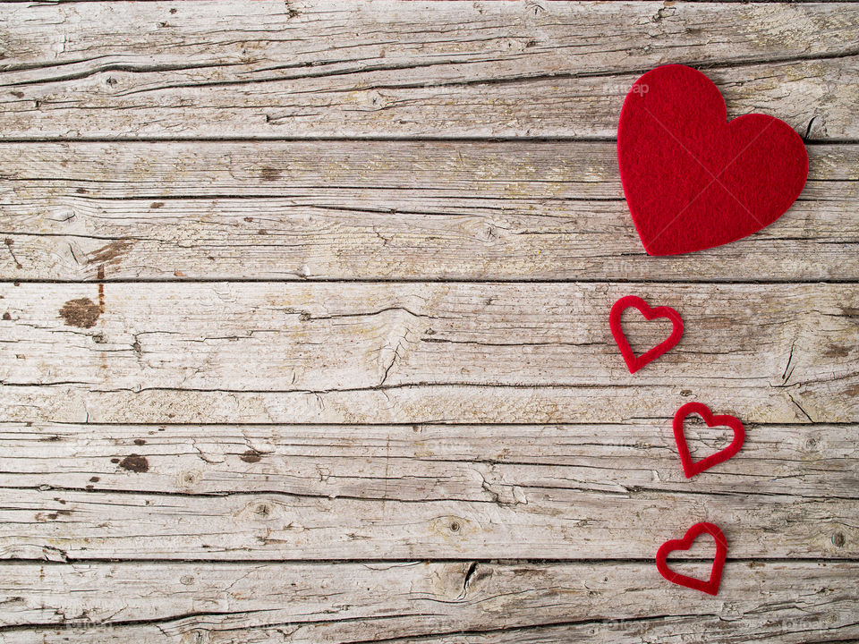 Red heart shape on vintage wooden background 