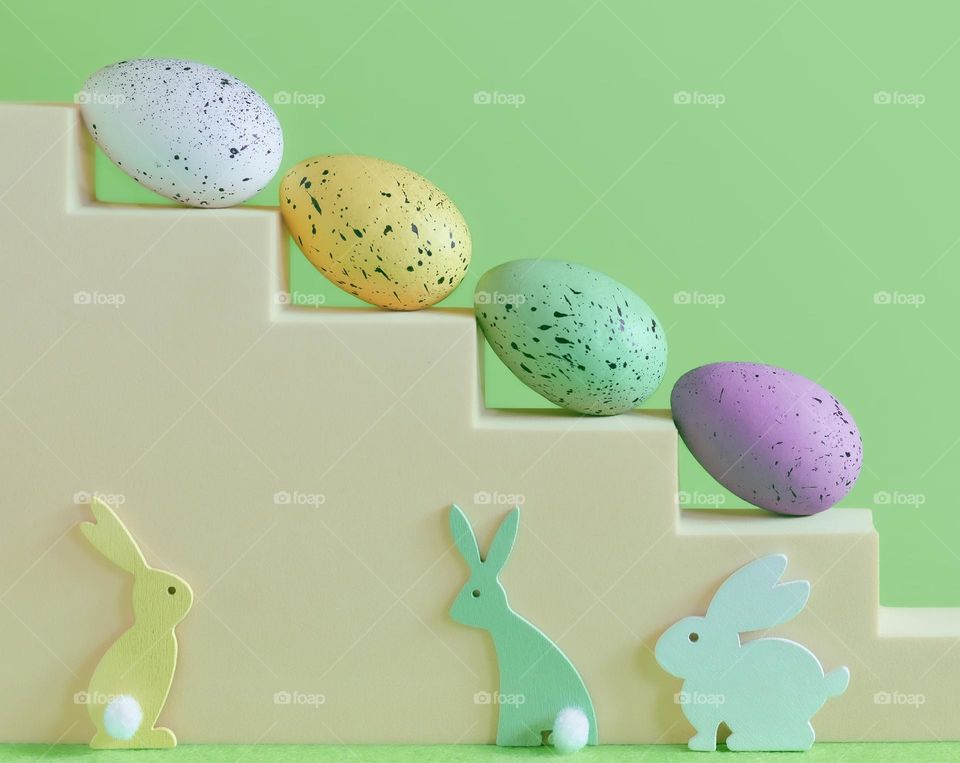 Eggs painted in spring colours with rabbit shapes