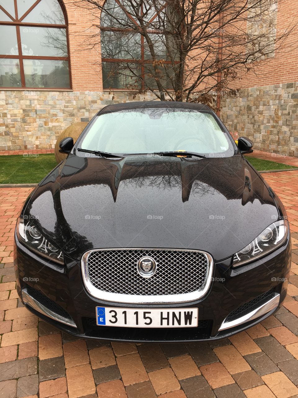 Jaguar XF black Sport parked on premium hotel