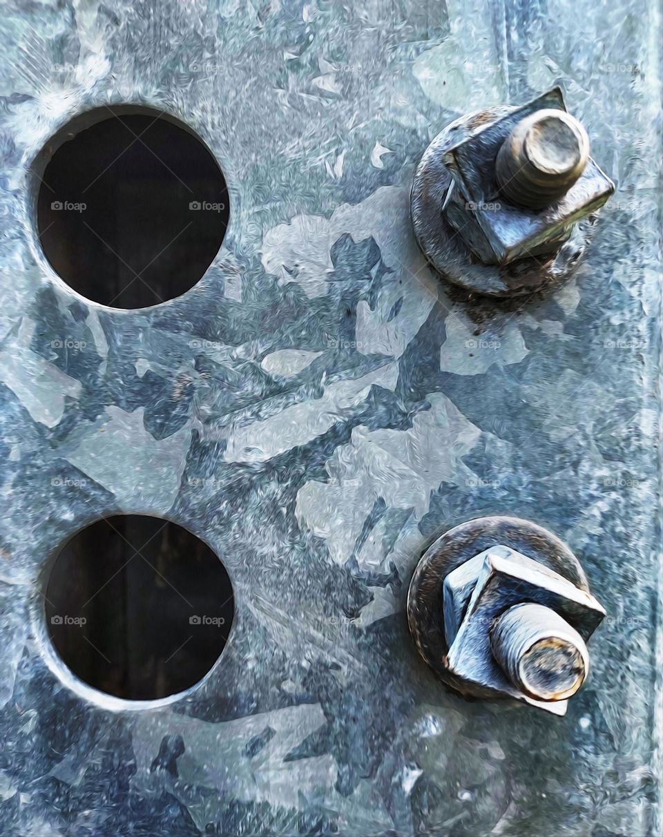 circles and  bolt holes in a man made electrical tower