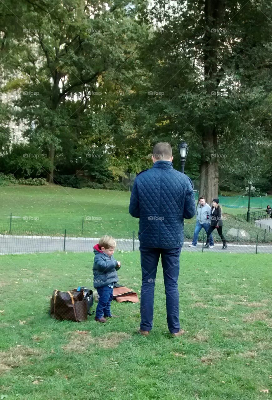 Son following Father looking hard at an object