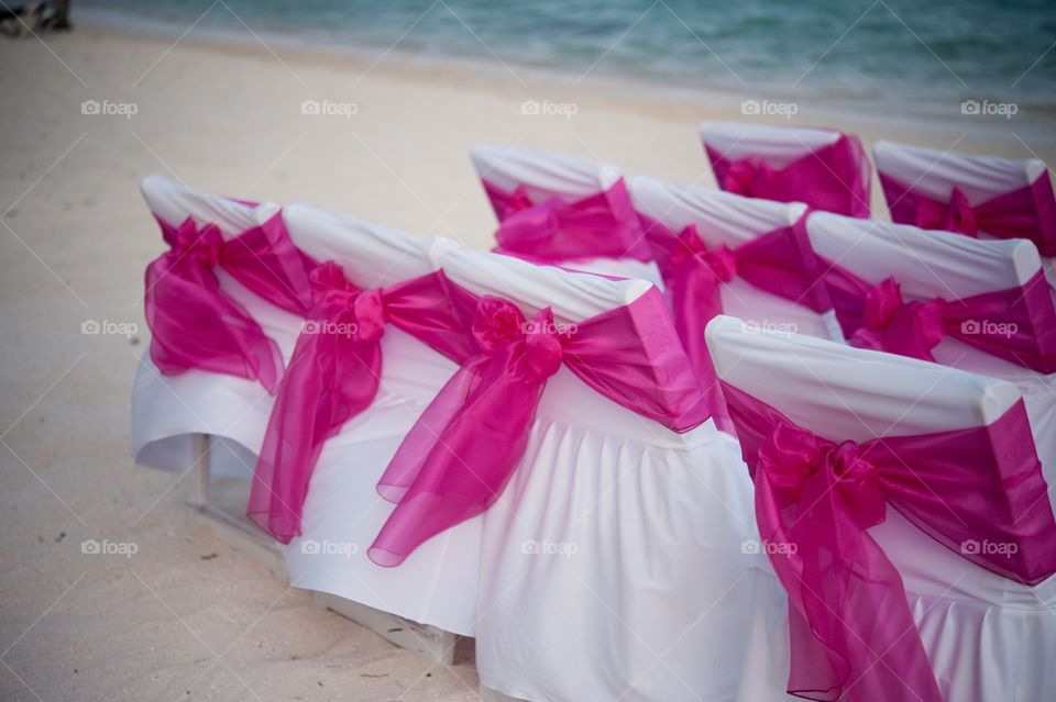Decorative chairs at a beach wedding