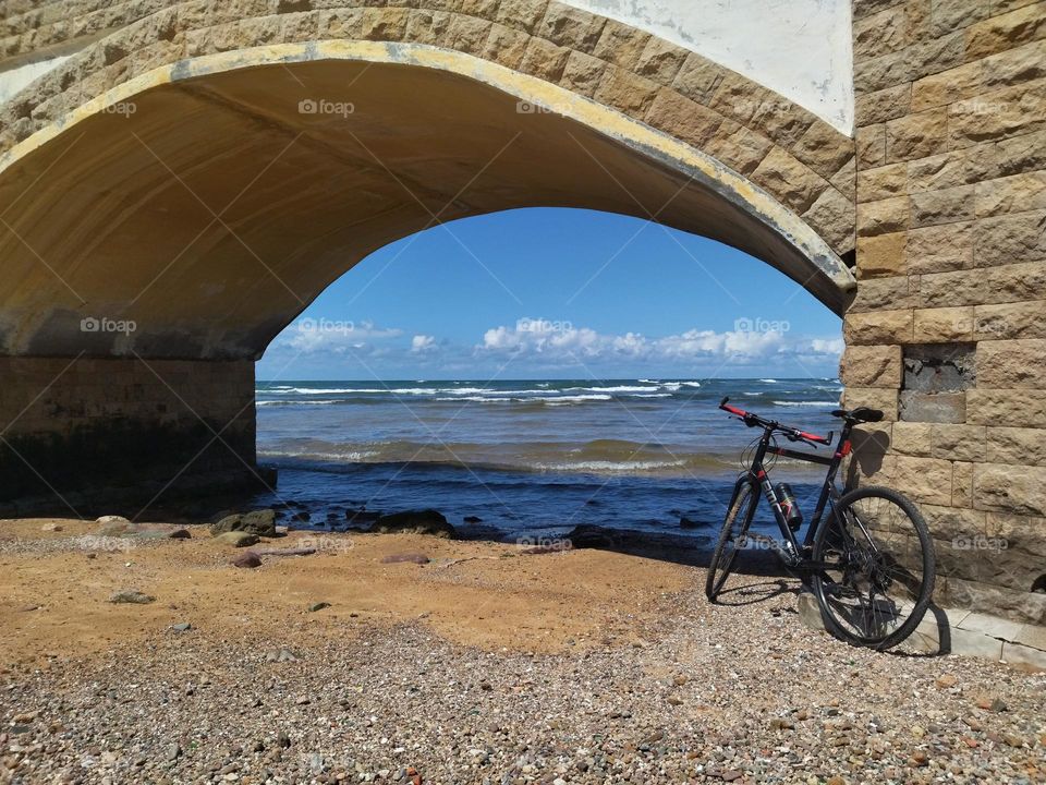 Bike under the bridge in the beach