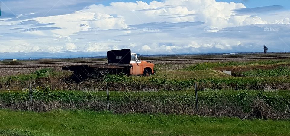 driving on HWY 5 we saw this lonely truck in a farm field