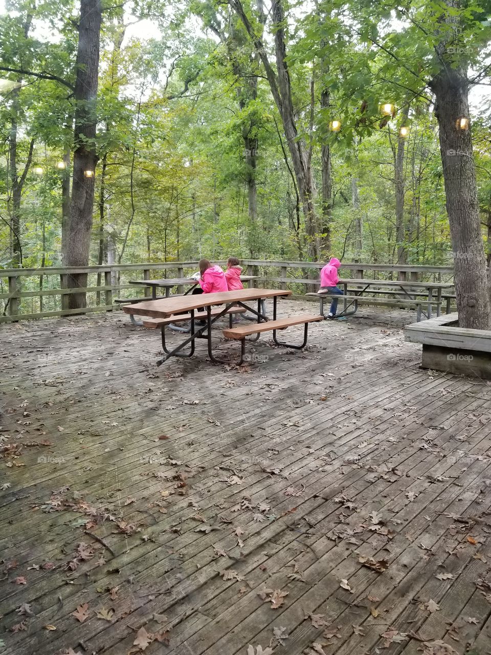 three girls on a deck