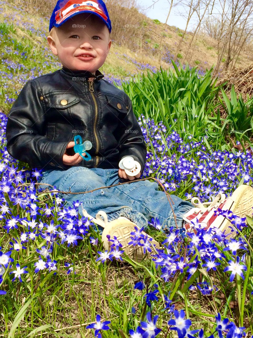 Happy in spring.. A little boy in a sea of flower.