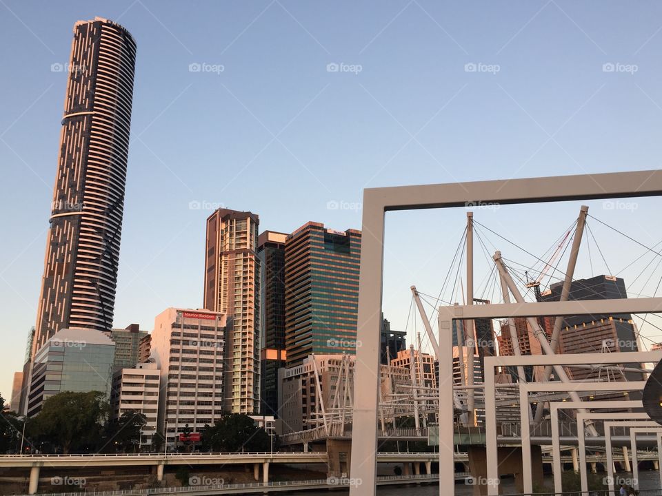 Kulripa Bridge, Brisbane, Australia which is a modern pedestrian and cycle bridge over the Brisbane River originally called Tank Street Brige with the city centre visible behind.
