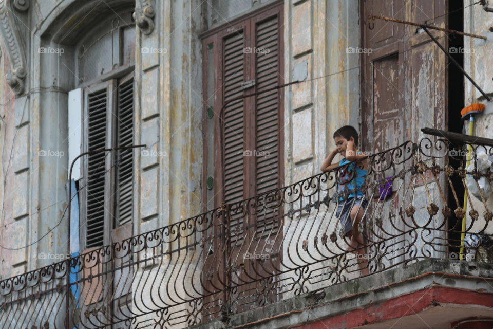 Boy on balcony in Havana