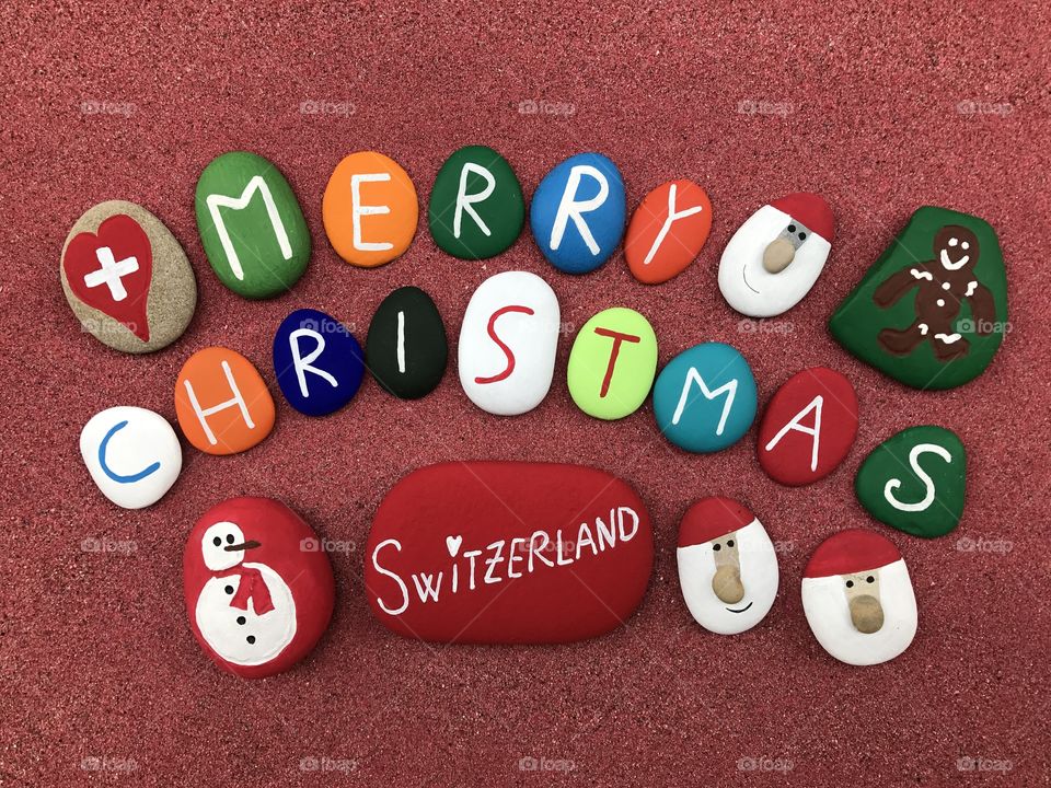 Merry christmas text with painted stones