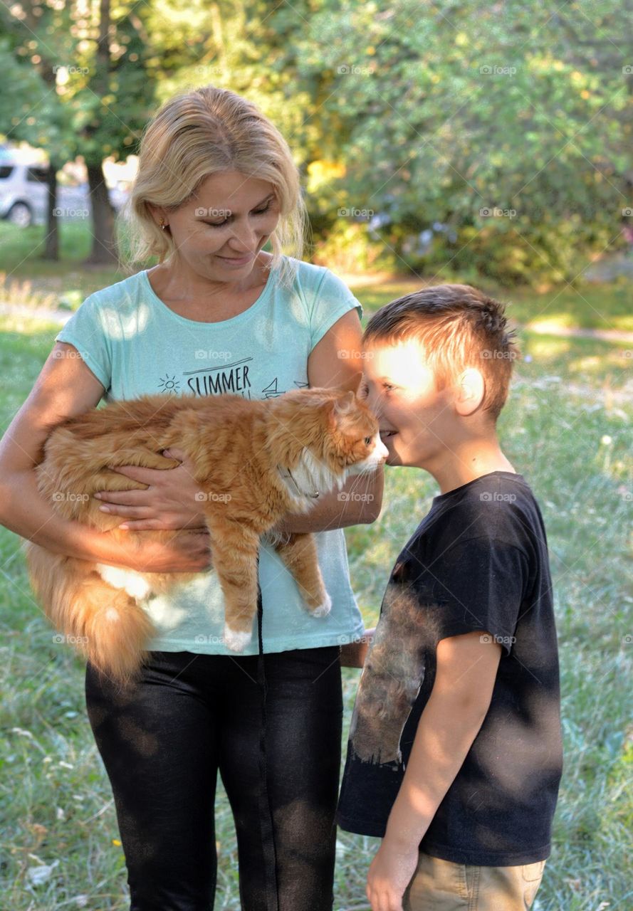 family with cat outdoor happiness