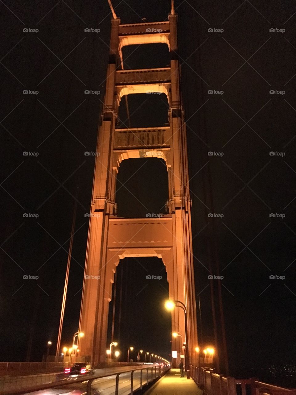 California landmark Golden Gate Bridge close up in San Francisco, lit up at night