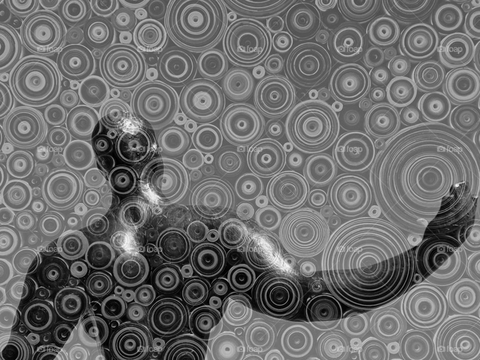 Overlapping images of a sculpture and a painting in black and white 