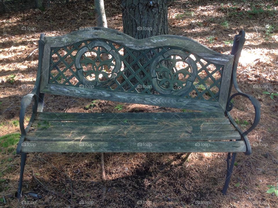 An old weathered broken bench in the yard. 