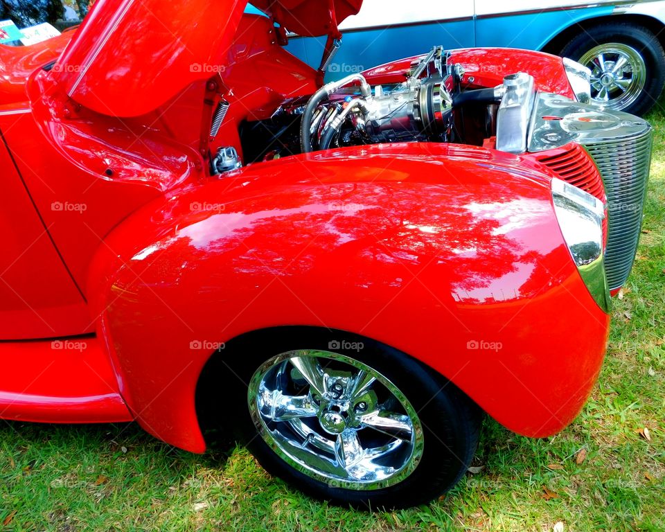 Color Red - A Shiny red fender on an antique Ford Coupe. The primary purpose is to prevent sand, mud, rocks, liquids, and other road spray from being thrown into the air by the rotating tire.