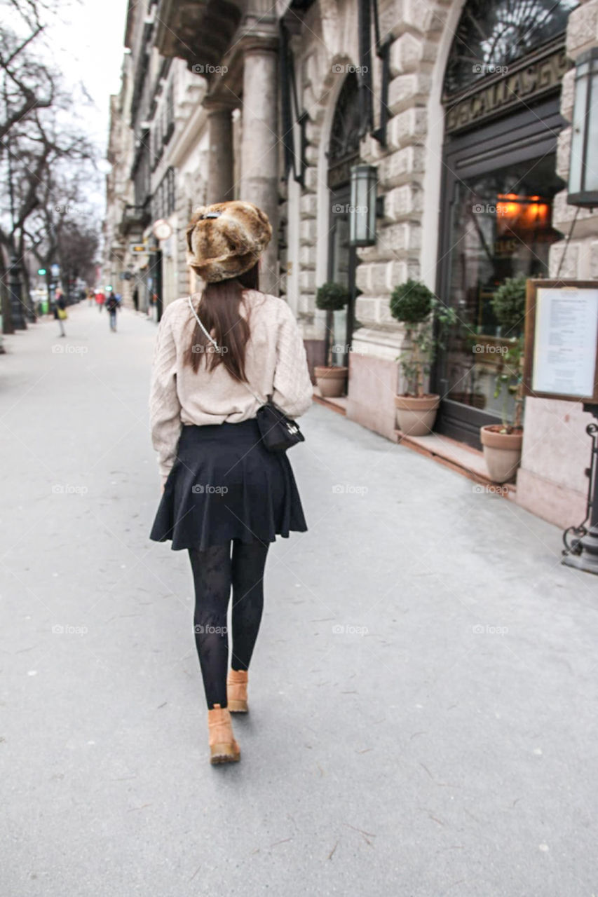 A girl in a beautiful outfit walking down to streets of Budapest and exploring the city