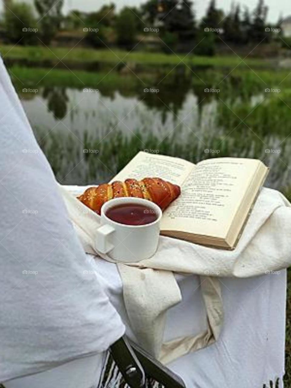 Enjoying my book with cofee, croissant and nature