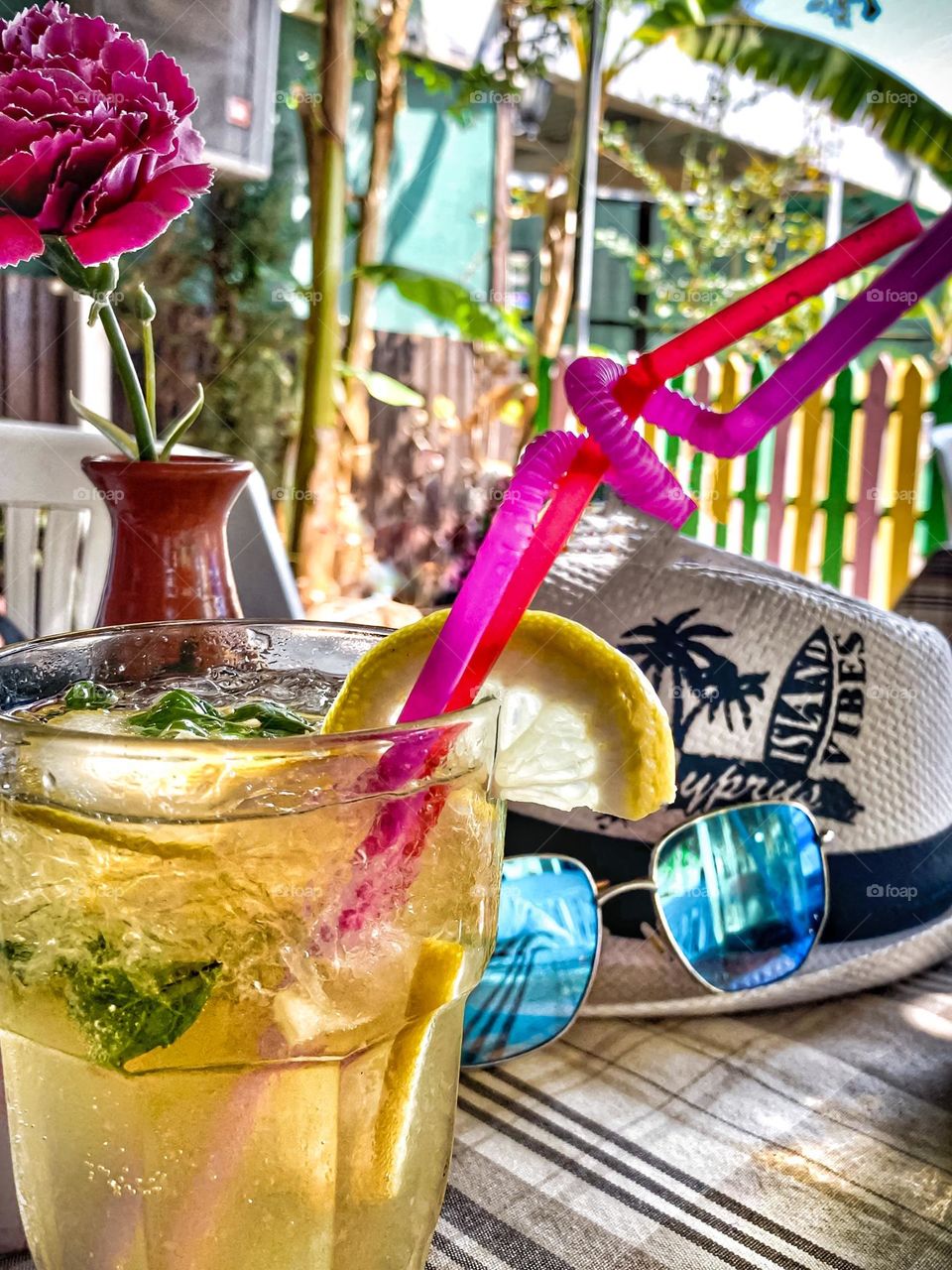 Mojito cocktail yellow color in a glass on a table in a cafe, summer drink, vacation