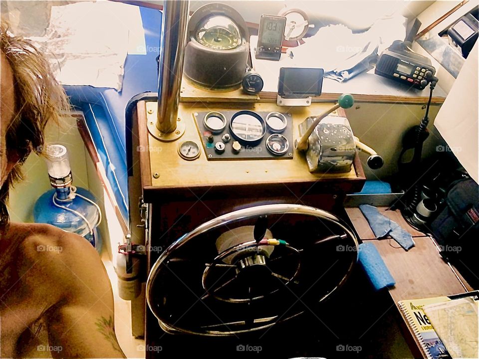 This is the cabin of our „28 foot 1969 Luhrs“ cabin cruiser that we call home with various technical controls, a chair and the inside steering wheel. The boat is tied to the shore at „Newtown Creek“ in LIC, Queens. 2018. Hypnotic Productions