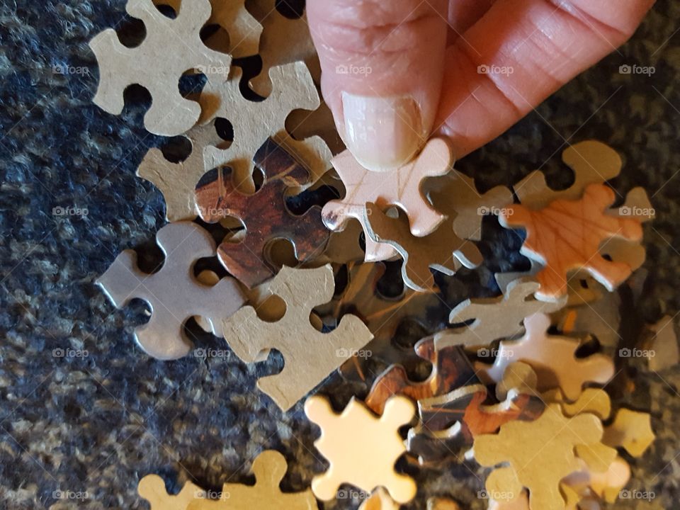 Man holding jigsaw puzzle pieces