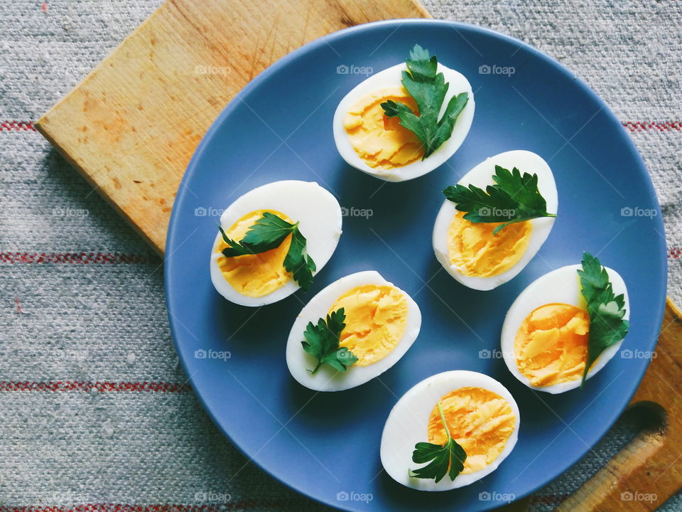 cut boiled eggs decorated with parsley