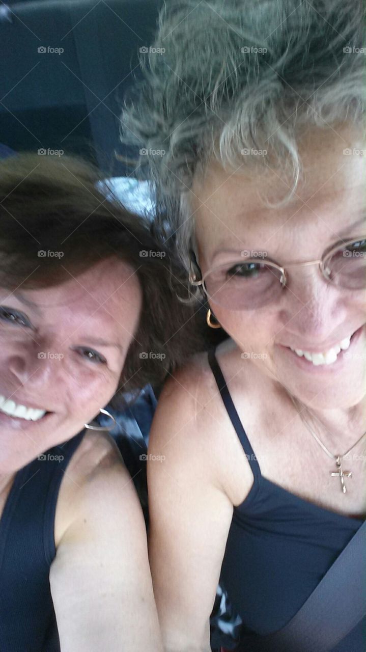 Sisters selfie together laughing in car driving on highway!