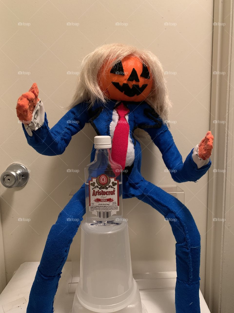 Pumpkin man is drinking just drinking 