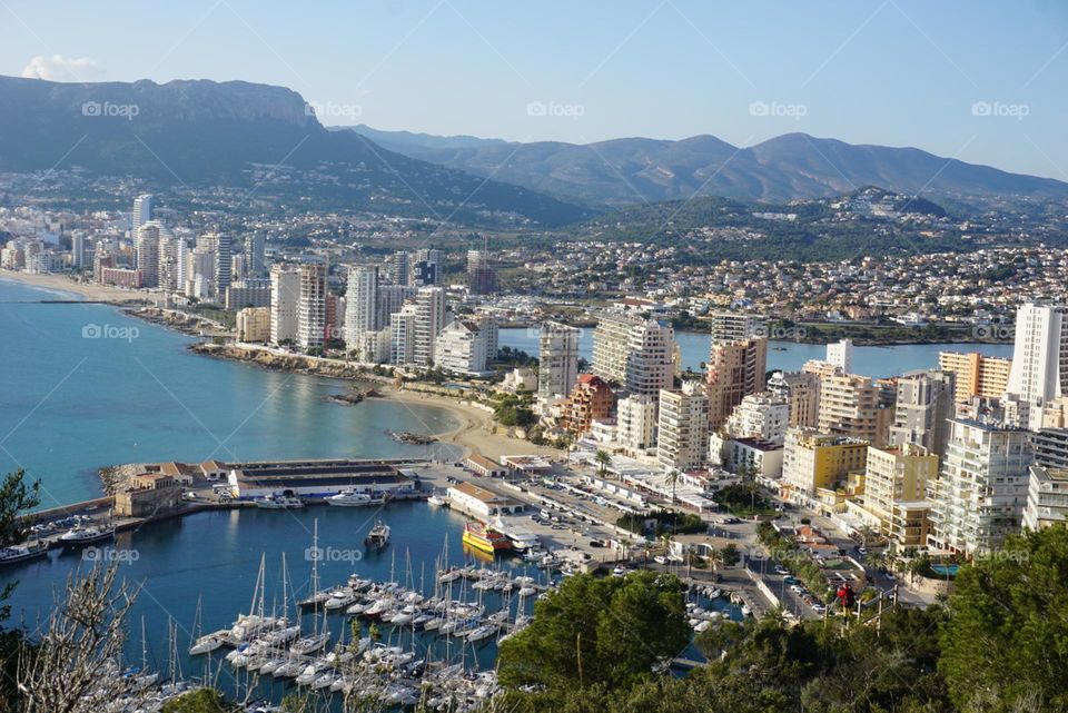 City#view#port#sea#buildings#boats#mountains