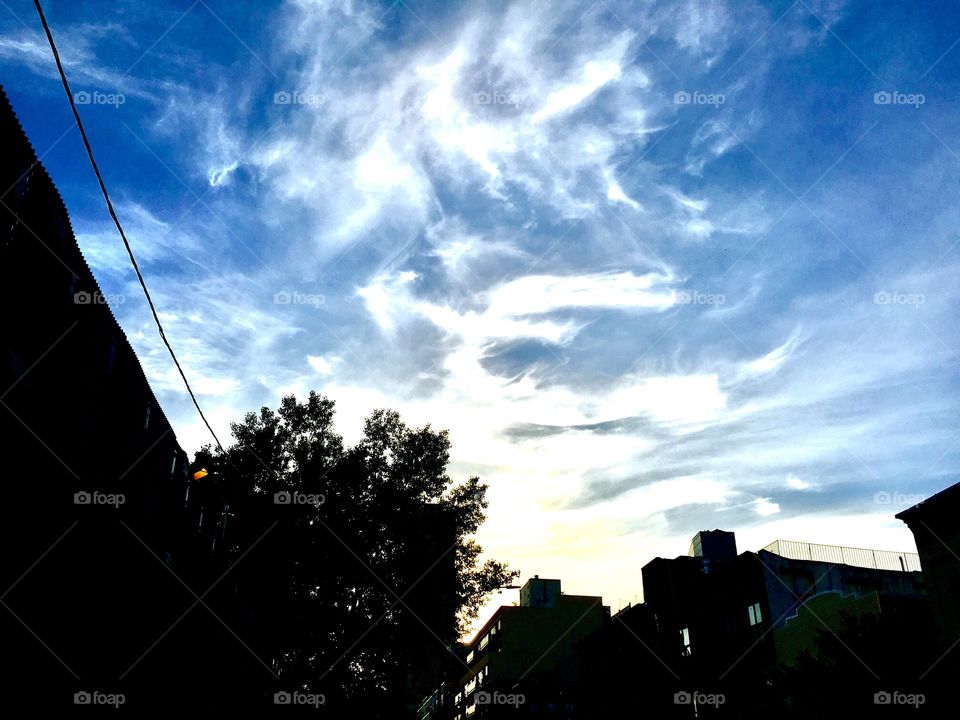 Clouds in the early evening skies of Long Island City, Queens, New York making interesting patterns. This picture was taken in the Spring of 2019. Hypnotic Productions