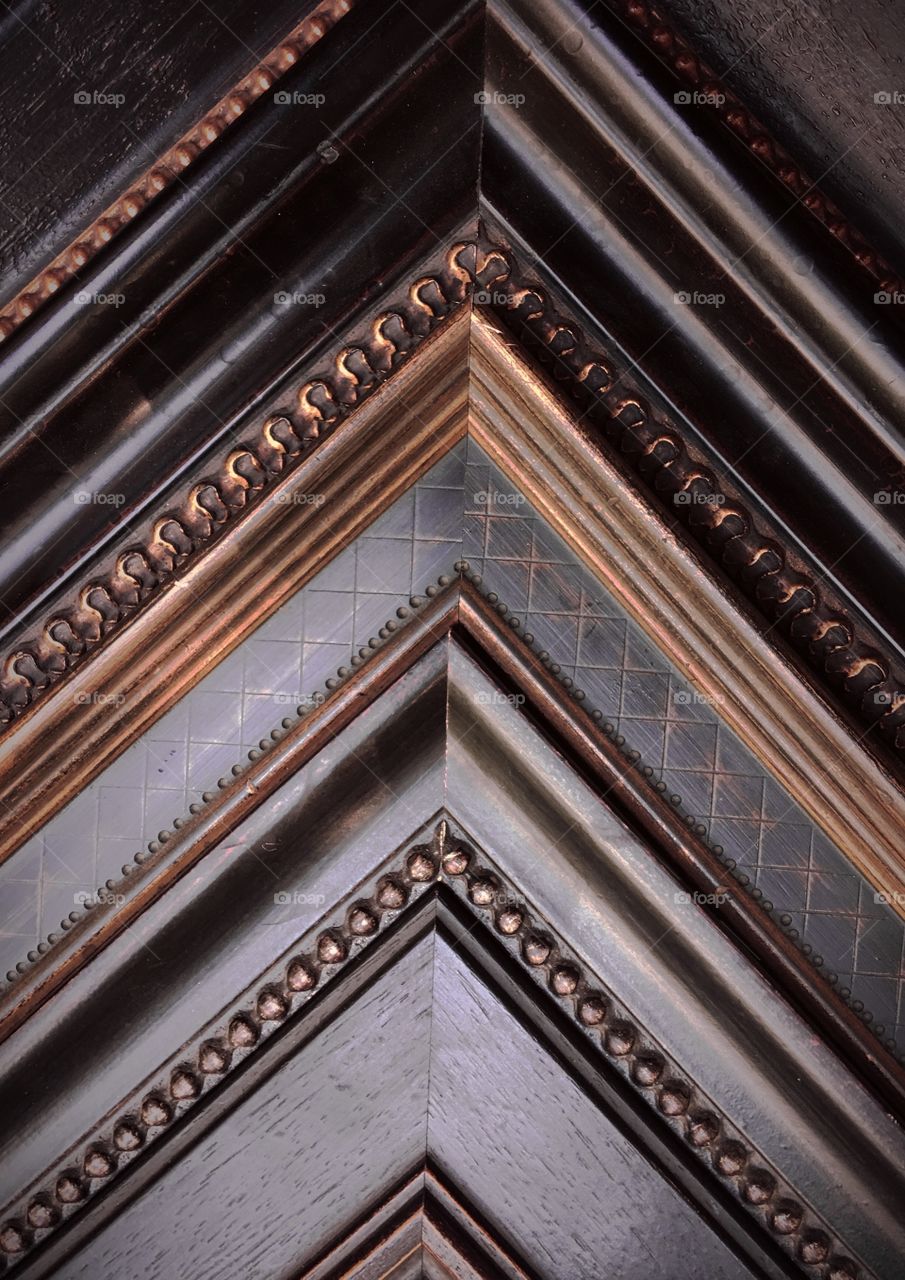 Dark wood art framing samples on wall