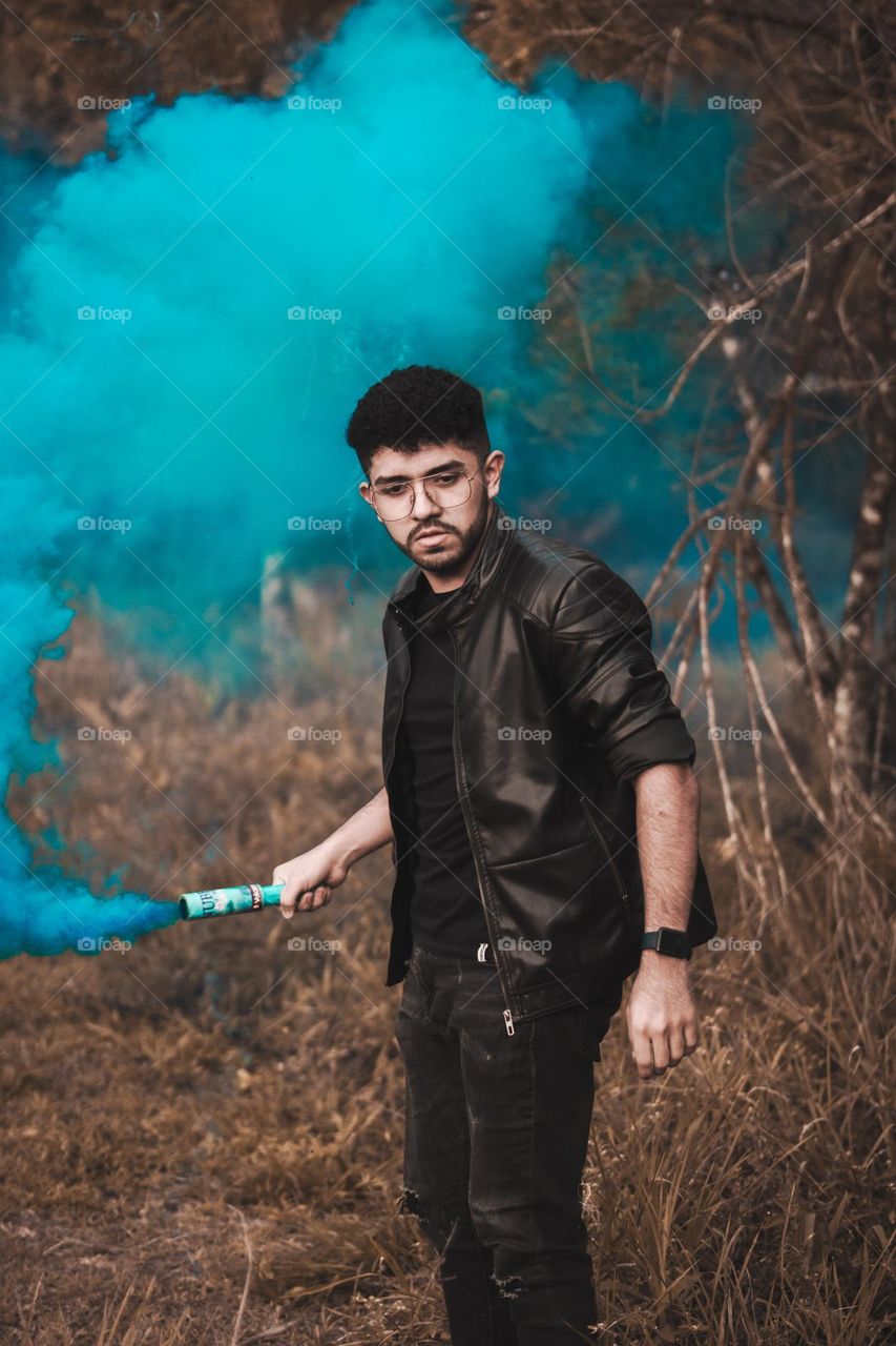 Photograph of man playing with smoke bombs