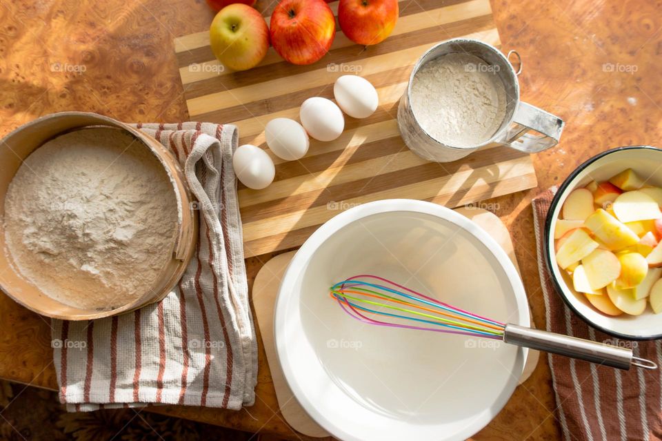 Making homemade puffed apple pie with eggs, sugar and flour.