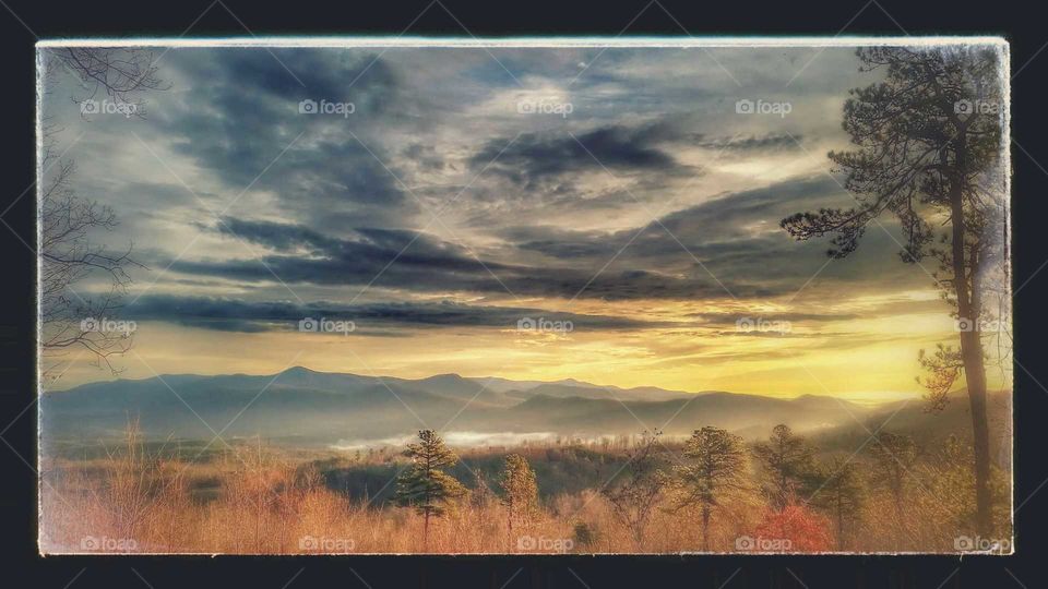 late fall in the smokey mountains, sunset sky with swirling storm clouds