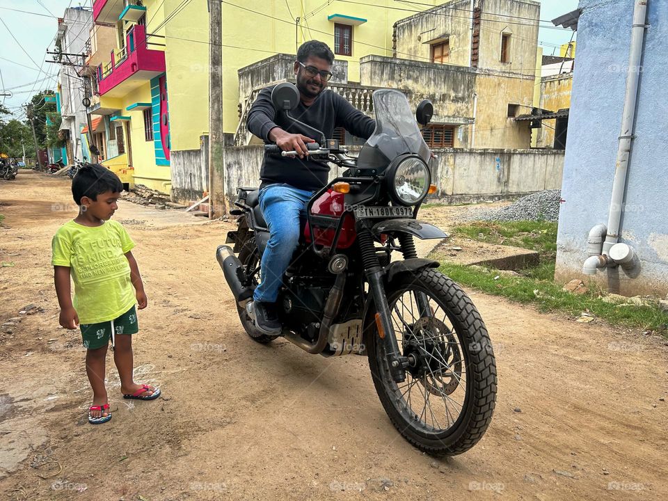 Kid watching a big motorbike 