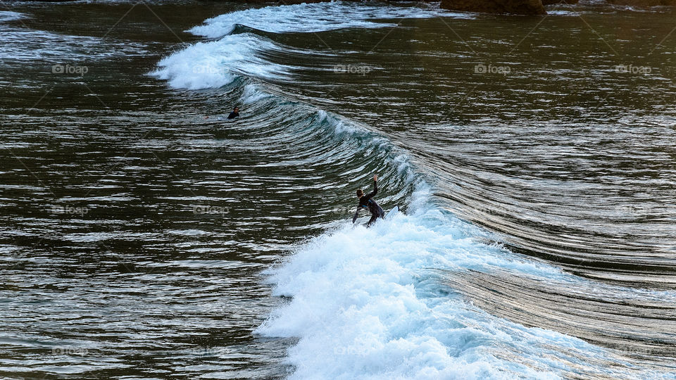 A man surfing at Antuerta beach, Spain