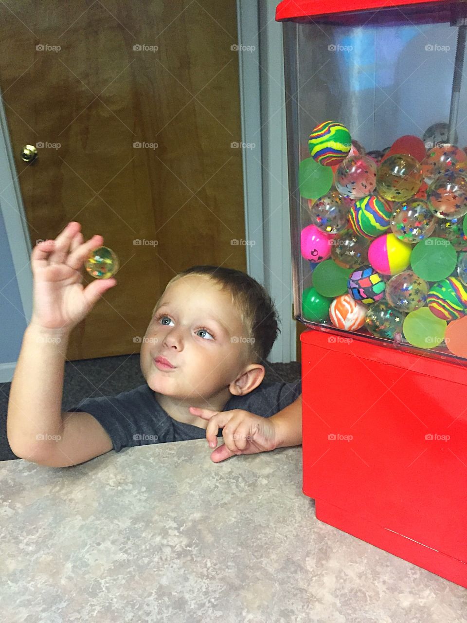 Small boy holding colorful ball in hand