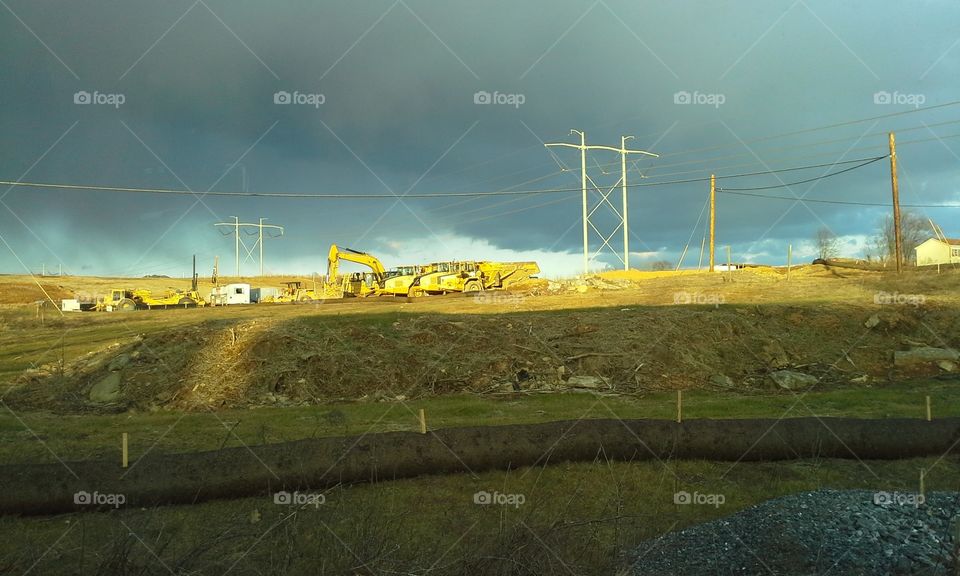 Stormy clouds at construction site with truck shadow