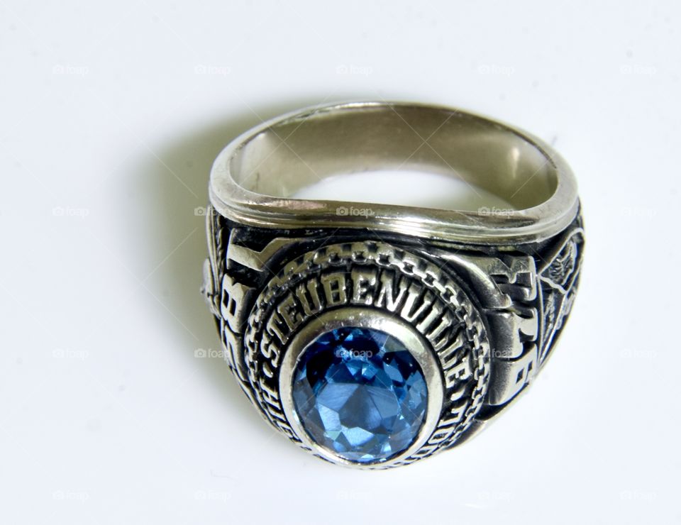 Class ring with blue stone and white gold band