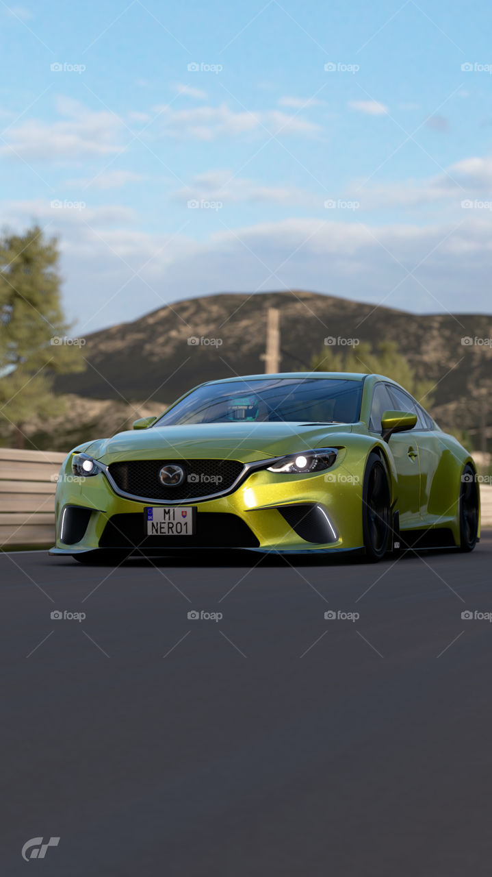 Yellow wide body kit Race modified Mazda 6 ( Atenza ) skyactive going fast on countryside road in the morning 