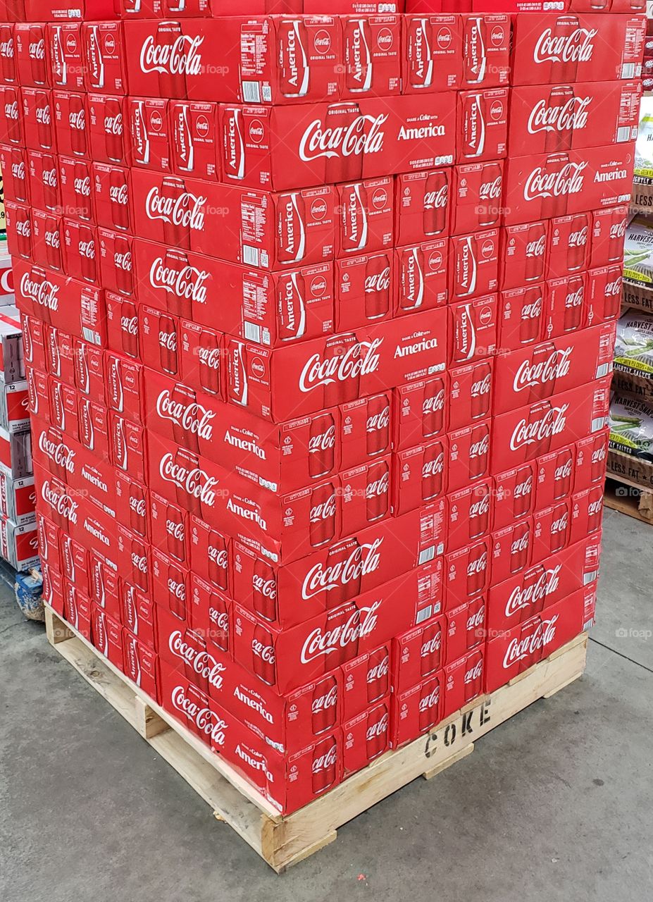 A pallet of CocaCola ready to be displayed at a grocery store.