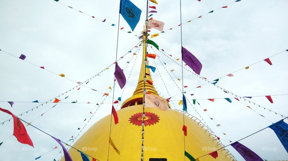 Golden pagoda decorated with flag colorful