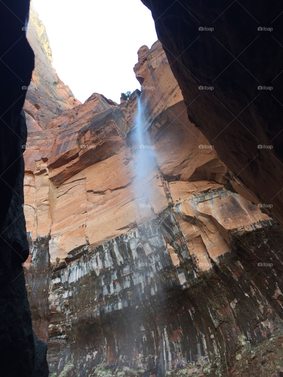 Waterfall down red rocks