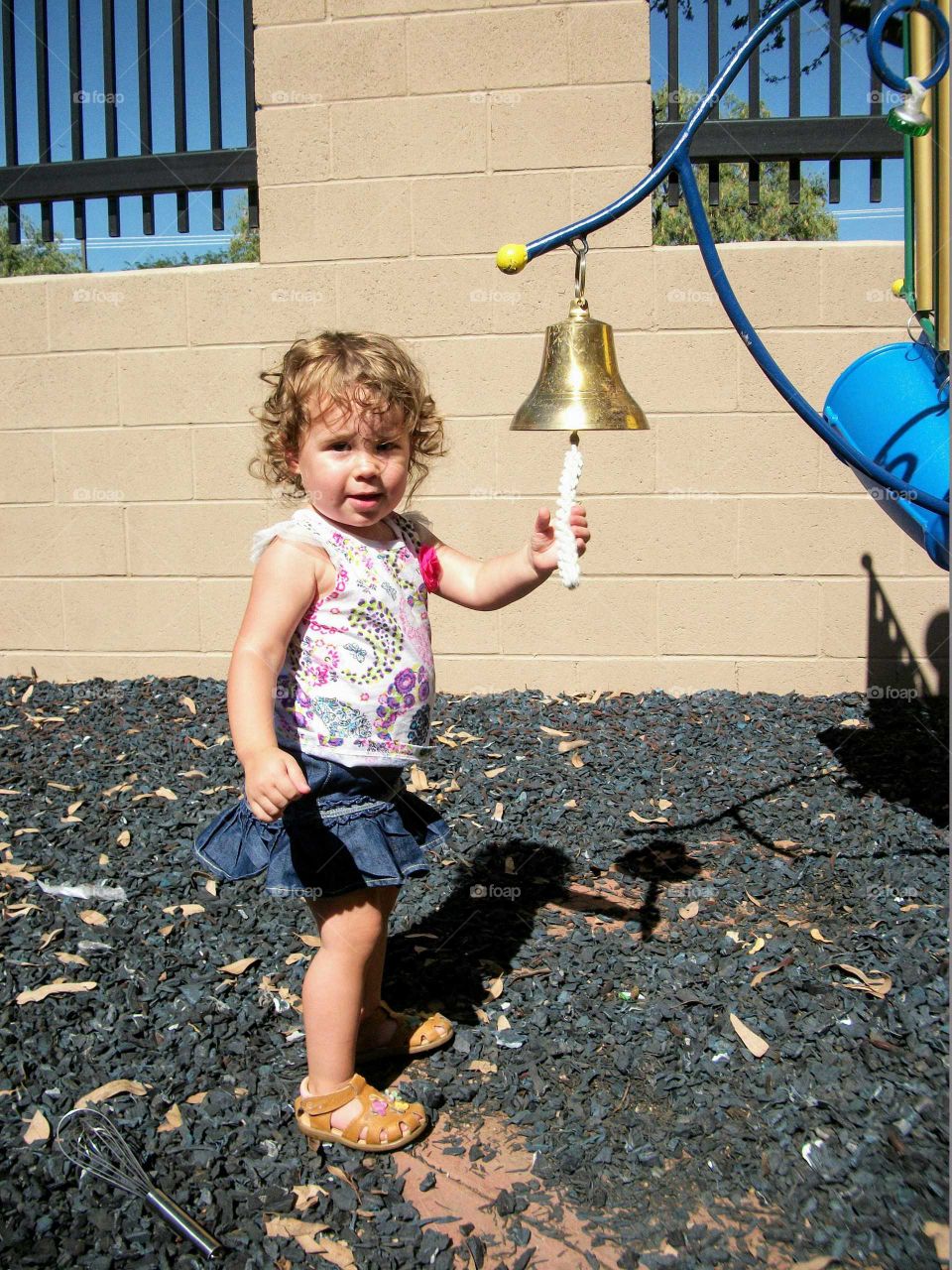 Girl ringing a bell