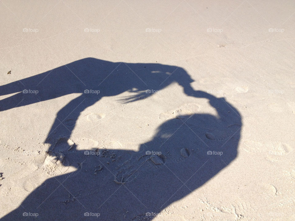 Sister love on the polish beach shown by shadow