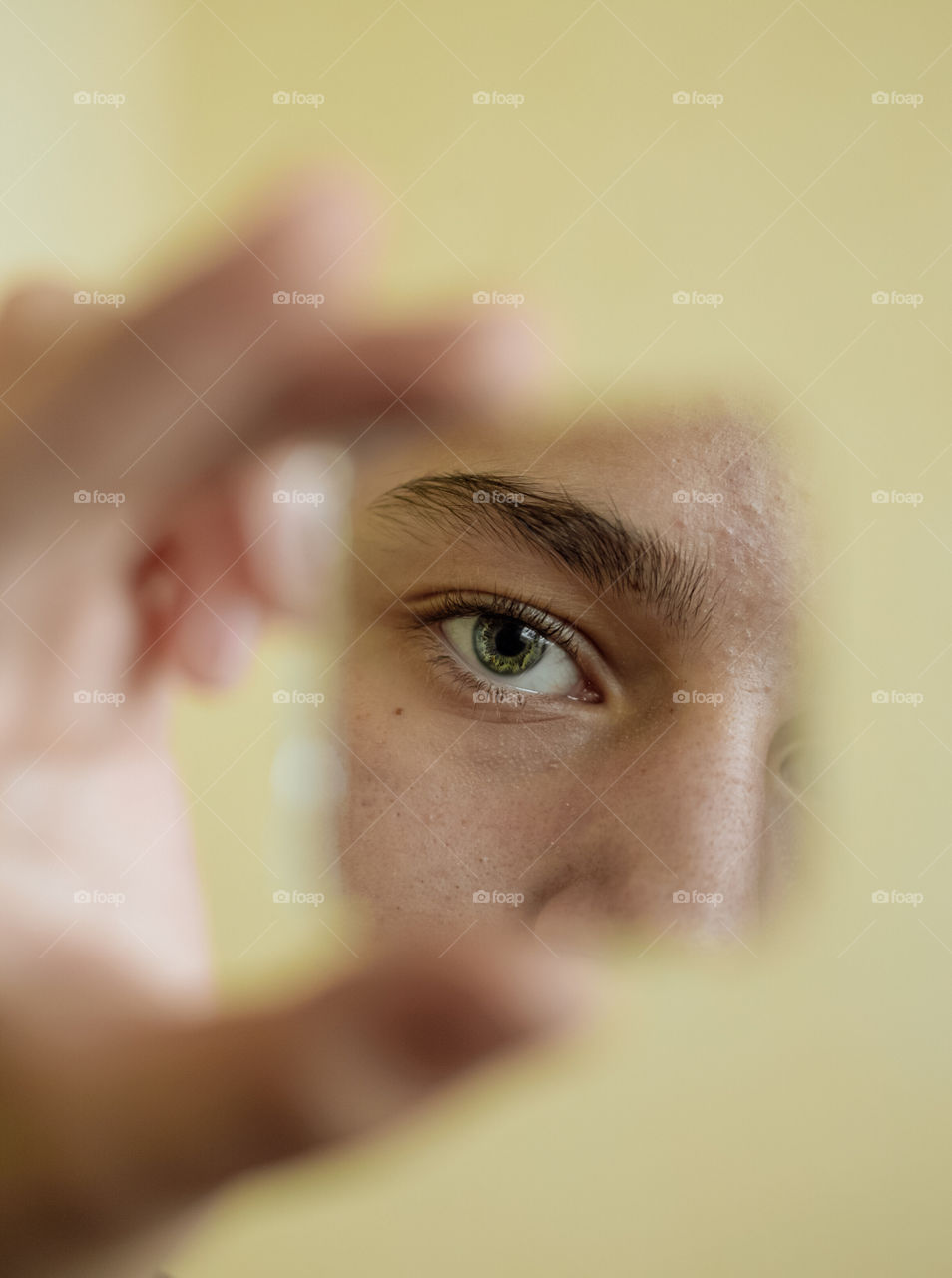 Close-up eye looking into broken mirror