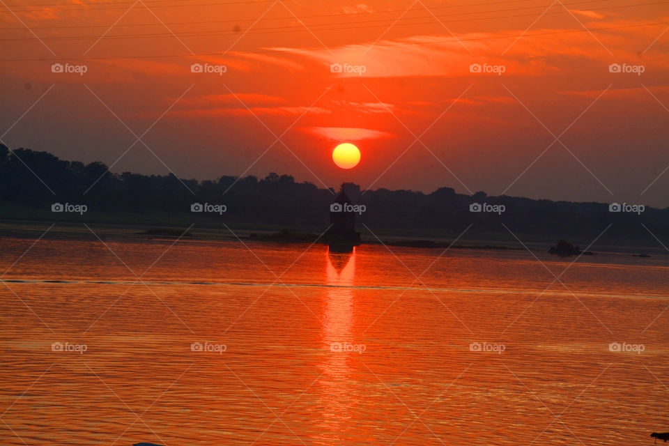 Beautiful scenery of reflection of light in water during the sun set