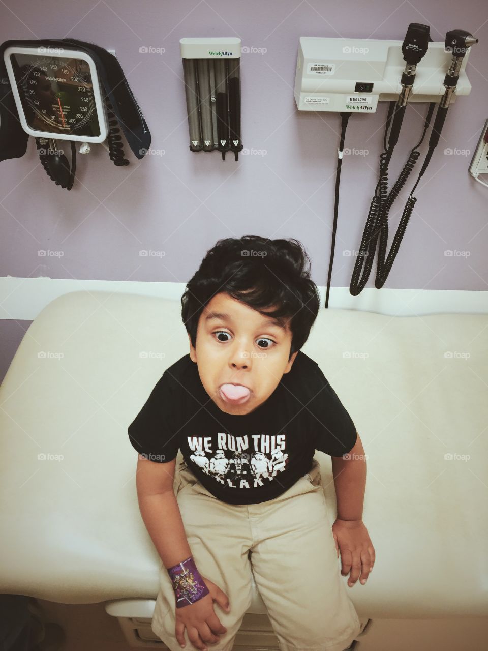 Funny face making kid at doctor appointment 