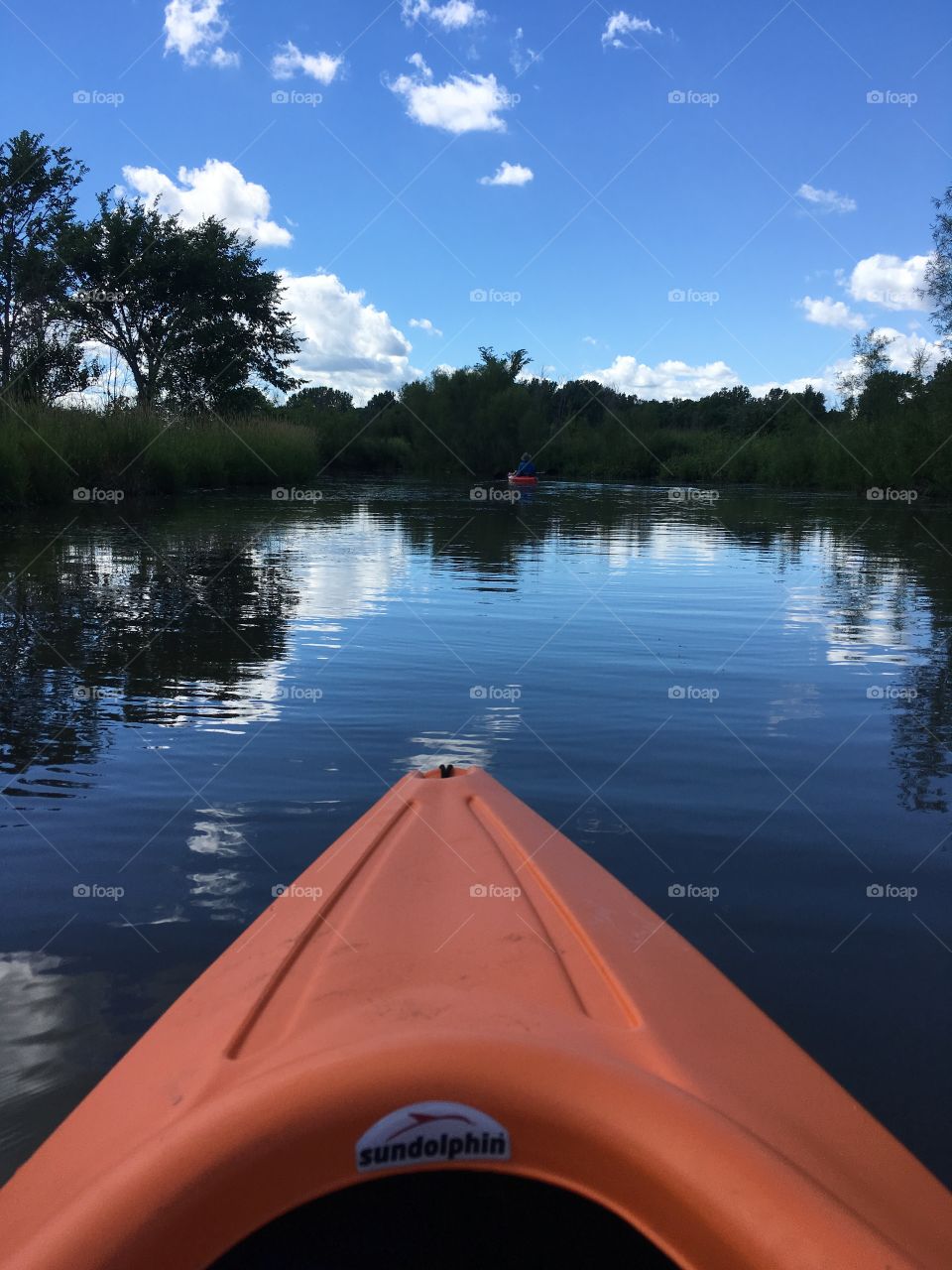 Kayaking on a beautiful summer day on a lake as smooth as glass