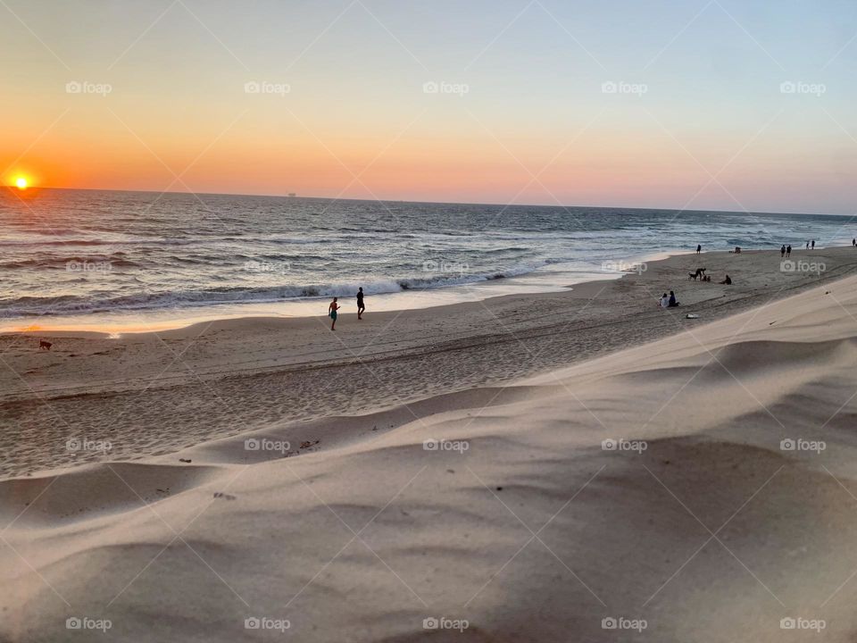  beach at sunset view from top of the sand dune 